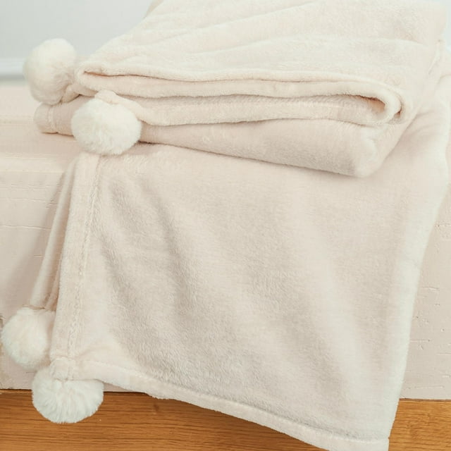 Cozy throw blanket draped over a couch in a living room