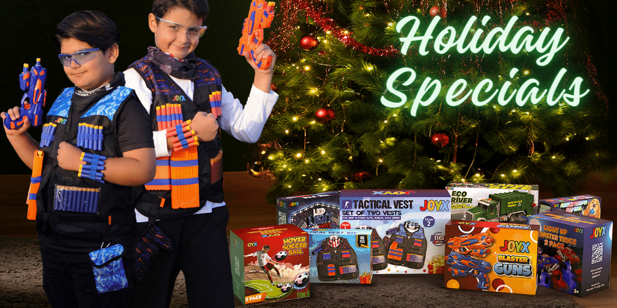 Two boys smiling, armed with toy blasters and wearing tactical vests, stand before a Christmas tree with 'Holiday Specials' glowing in neon. The tree sparkles beside boxes of JoyX toys, promoting festive deals on children's gifts.