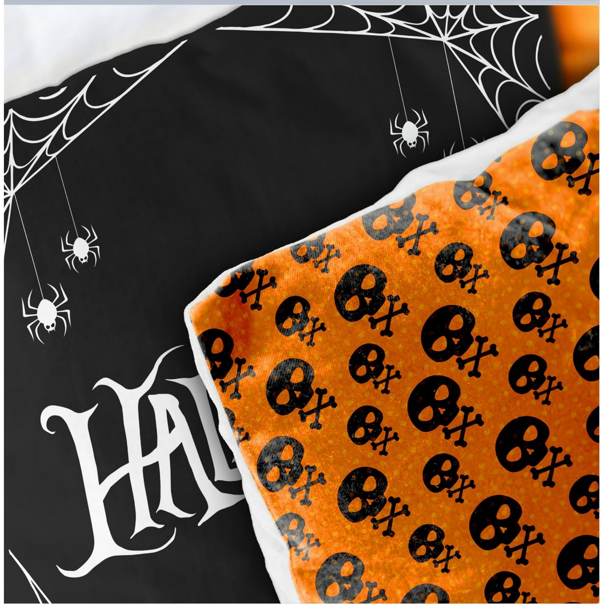 A Halloween-themed pillow with a spider web and skull and crossbones pattern.
